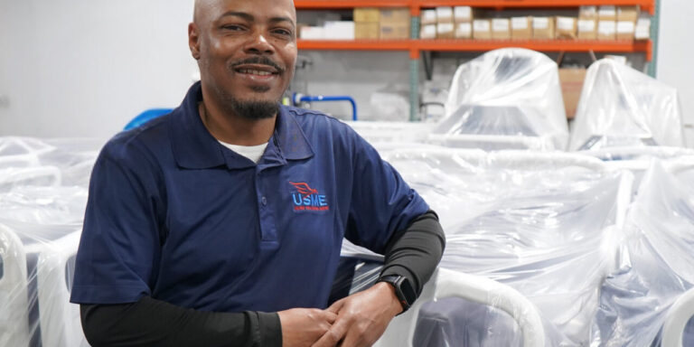 USME Team Lead standing beside a patient-ready hospital bed
